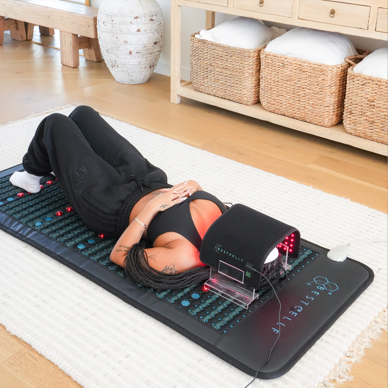Eisha using hte red light wrap and PEMF mat by BEST CELLF