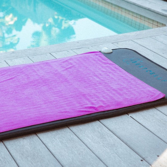 Magenta microfibre towel on full-body PEMF mat